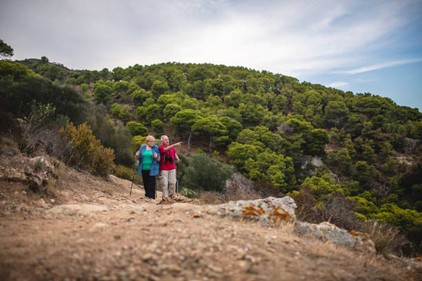 istock Senior Spanish Day Hikers Looking at Mediterranean Vista 1184651854