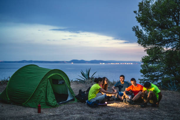 Friends Sitting at Campsite Overlooking Mediterranean
