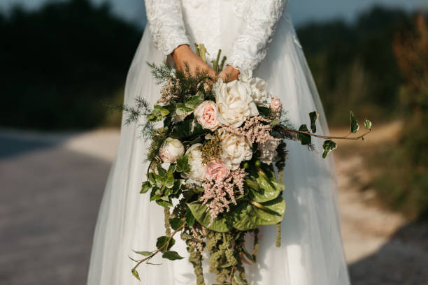 istock Bride holding beautiful bouquet in one hand. No face. Close up. 1184653573