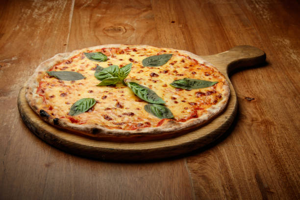 istock pizza with basil, Italian dish, pizzeria, presentation 1184653829