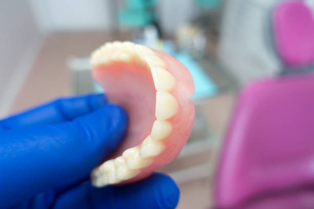 istock removable denture in the hands of a doctor 1184654685