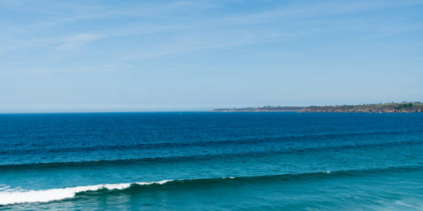 surfable waves from a ground swell roll into the Blancs Sablons beach on the coast of Brittany in France