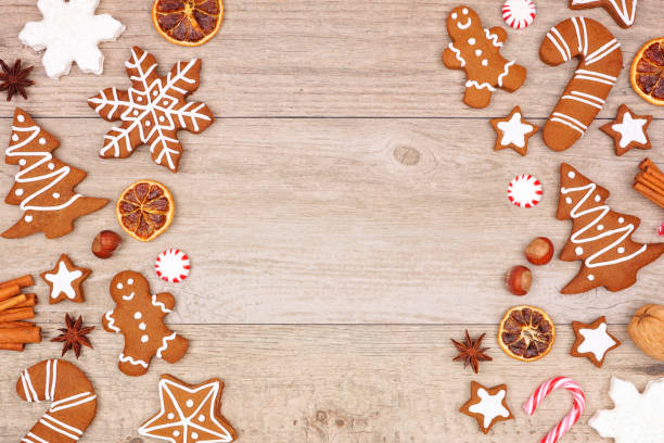 istock Christmas gingerbread cookies, candy and baking items, double side border on a wood background 1184657878