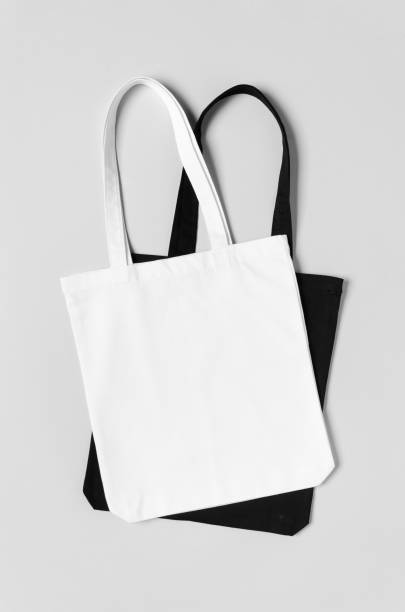 istock White and black tote bags mockup on a grey background. 1184658932