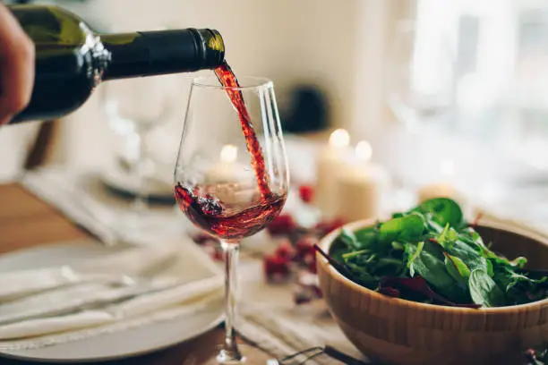 Photo of Red wine being poured into the glass