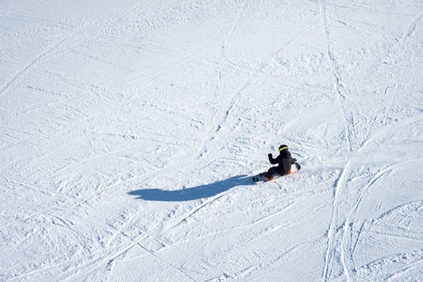 High angle view of unrecognizable person snowboarding