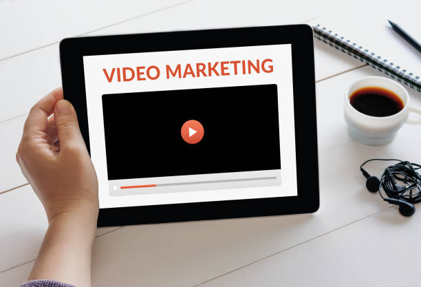 istock Hand holding tablet with video marketing concept on screen 1184663129