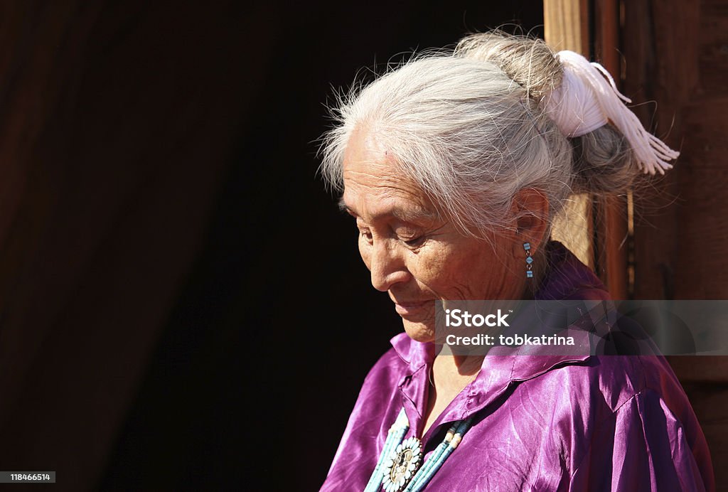 Navajo Woman Looking Down Outdoors in Bright Sun  Senior Adult Stock Photo