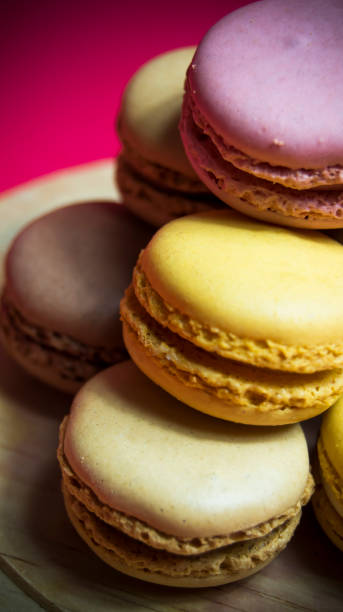 istock Colored macarons isolated on wooden dish, typical French dish 1184665607