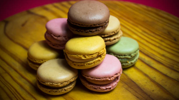 istock Colored macarons isolated on wooden dish, typical French dish 1184665885