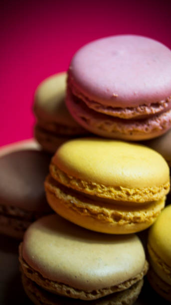 istock Colored macarons isolated on wooden dish, typical French dish 1184666374
