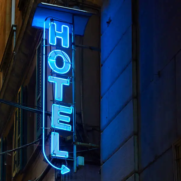 Neon hotel sign on the wall in the night