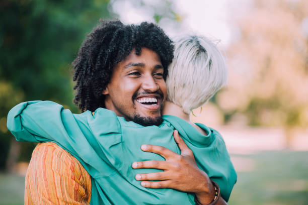 istock Young man embracing his girlfriend in the park 1184667386