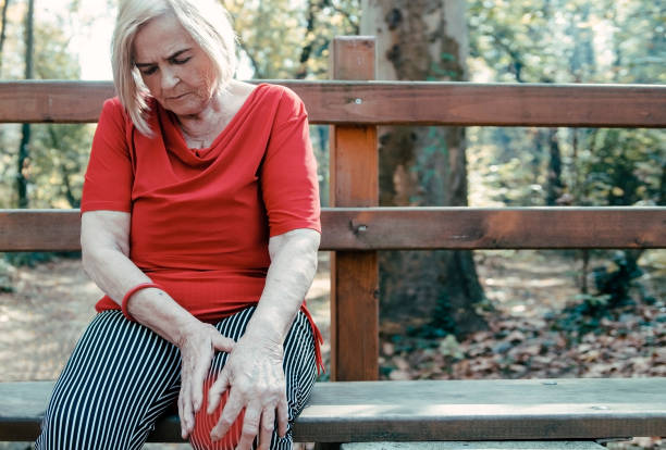 istock Very old woman suffering from knee pain outdoors.Copy space 1184668004