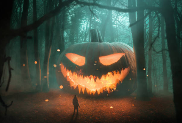Abstract Jack 'o Lantern pumpkin in the dark forest at night