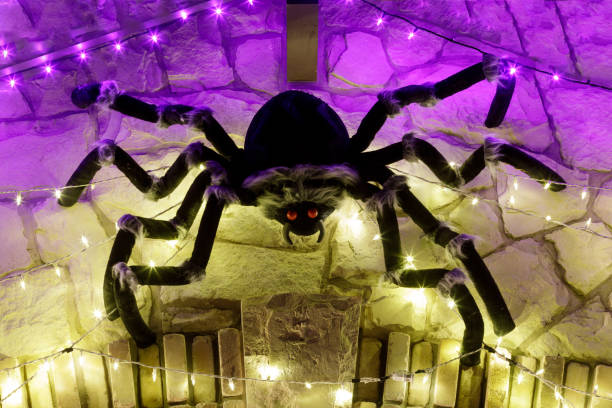 istock Halloween giant black spider in led lights web. 1184670105