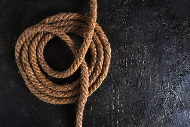 istock Coiled roll of jute rope on abstract background. 1184670678