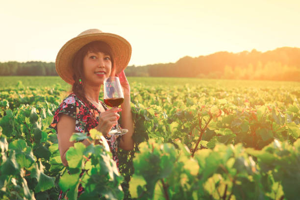 istock Asian woman drinking red wine at vineyard 1184671041