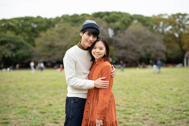 istock Portrait of young couple embracing in park 1184673473