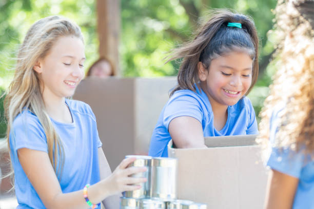 istock Elementary age girls volunteer their time 1184674108
