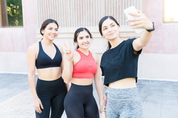 istock Young Multiethnic Female Athletes With Mobile Phone 1184674717
