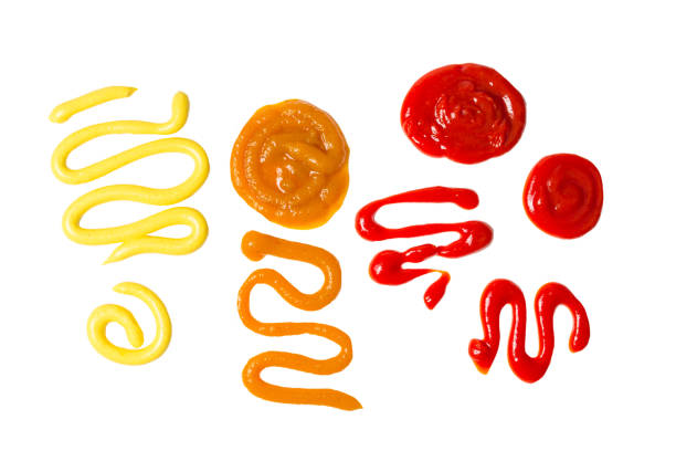 istock Ketchup and yellow sauce splashes isolated on white background. 1184675703