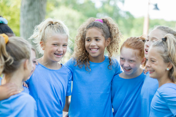 istock Girls smile during huddle at soccer game 1184676337