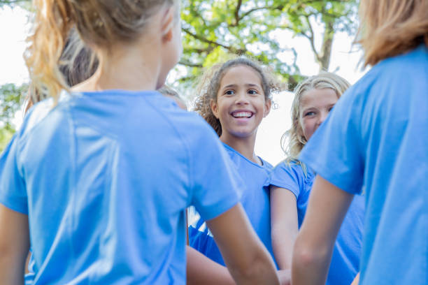 istock Soccer team put hands in during huddle 1184676344