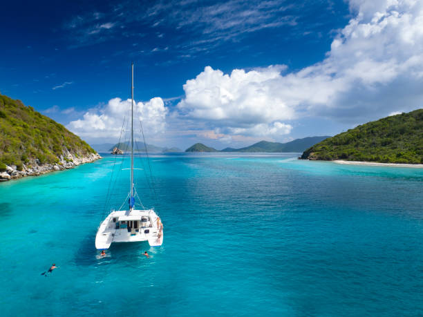 catamaran anchored with peope relaxing by lovango cay, virgin islands - vacations couple travel destinations snorkeling imagens e fotografias de stock