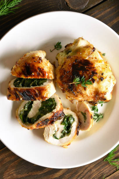 istock Sliced stuffed chicken fillet with spinach and cheese 1184680427