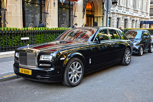 Paris, France - April 18th 2015 : Half-face Black Rolls Royce Phantom parked in a street, in George V quarter.