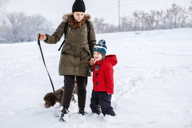 istock Happy young family playing in fresh snow 1184689385
