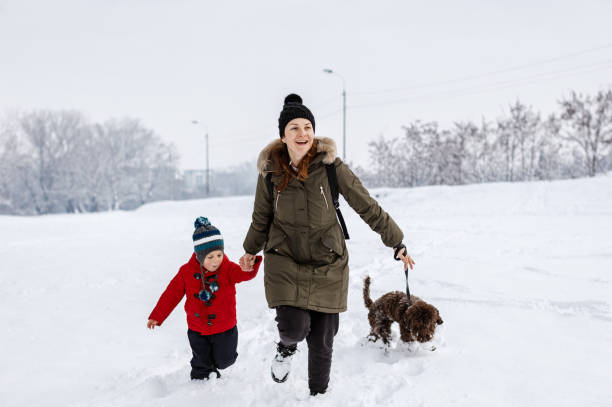 istock Happy young family playing in fresh snow 1184689433