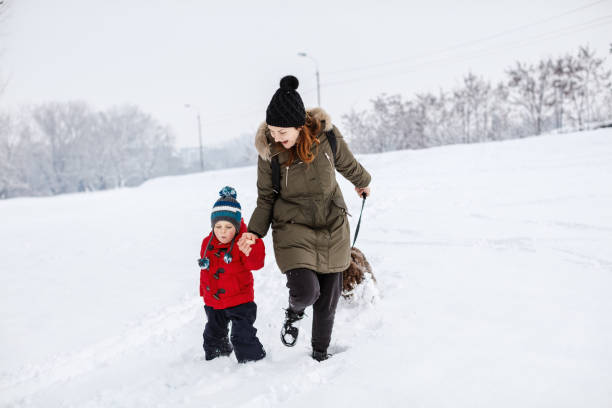 istock Happy young family playing in fresh snow 1184690691
