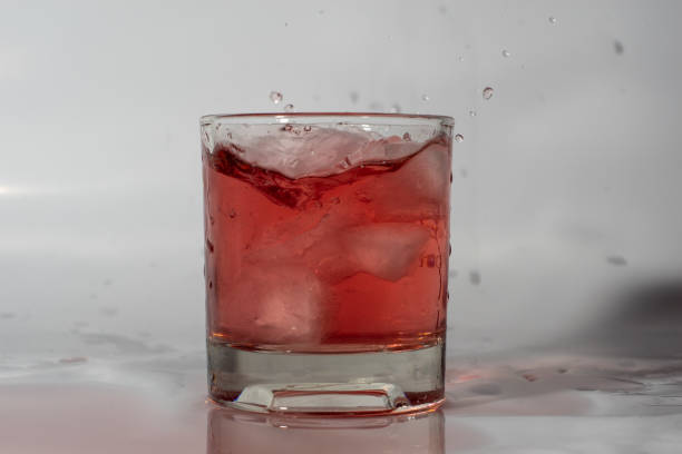 istock A glass with a drink and ice. Ice falling in 1184691561
