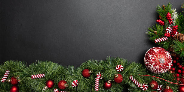 istock Xmas bauble shiny red color against grey black background, high angle 1184691718