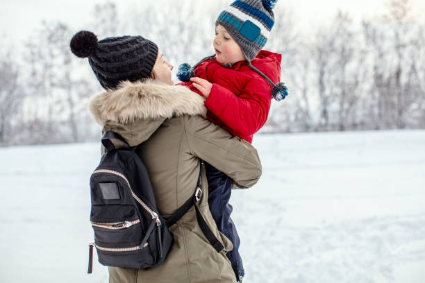 istock Mother and son having fun at snow 1184691759