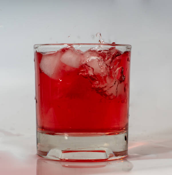 istock A glass with a drink and ice. Ice falling in 1184691909