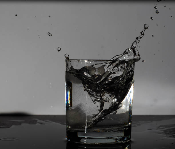 istock A glass with a drink and ice. Ice falling in 1184692392