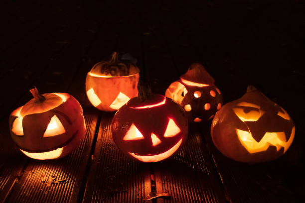 istock Spooky Halloween pumpkin, Jack O Lantern, with burning candles 1184693495