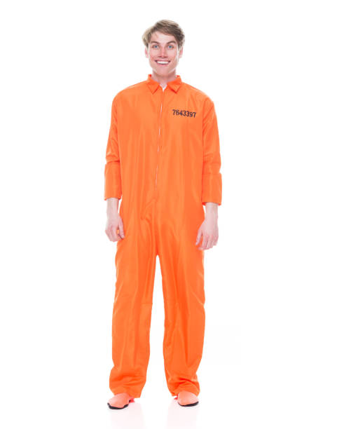Full length / one person of 20-29 years old adult handsome people caucasian young men / male in front of white background wearing jumpsuit / uniform who is excited / happy / smiling / crime Full length / one person of 20-29 years old adult handsome people caucasian young men / male in front of white background wearing jumpsuit / uniform who is excited / happy / smiling / crime jumpsuit stock pictures, royalty-free photos & images