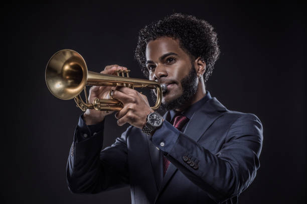 istock Black Man playing jazz trumpet in a studio shot 1184696383