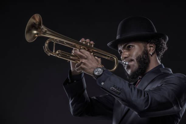 istock Black Man playing jazz trumpet in a studio shot 1184696446