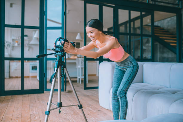 istock Fitness blogger fixing camera before making video 1184699188