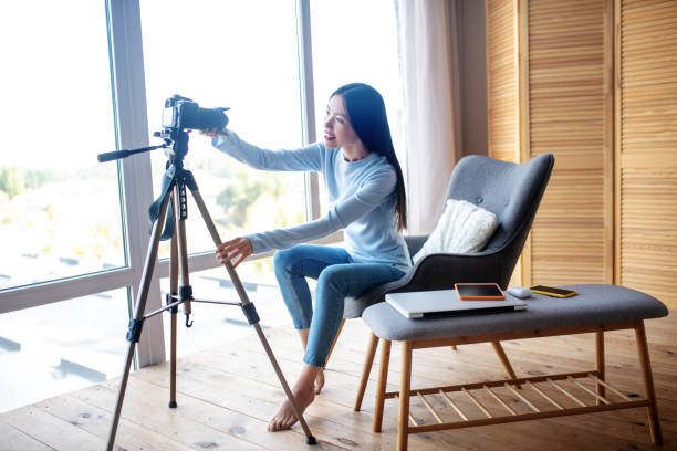 istock Dark-haired influencer getting ready for filming blog 1184700020