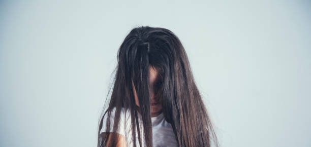 istock sad little girl in studio 1184700171