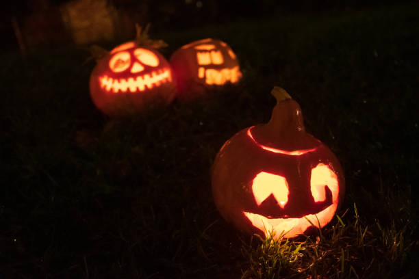 istock Spooky Halloween pumpkin, Jack O Lantern, with burning candles 1184701631