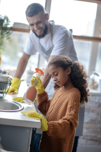 istock Girl helping daddy to clean kitchen at the weekend 1184704791