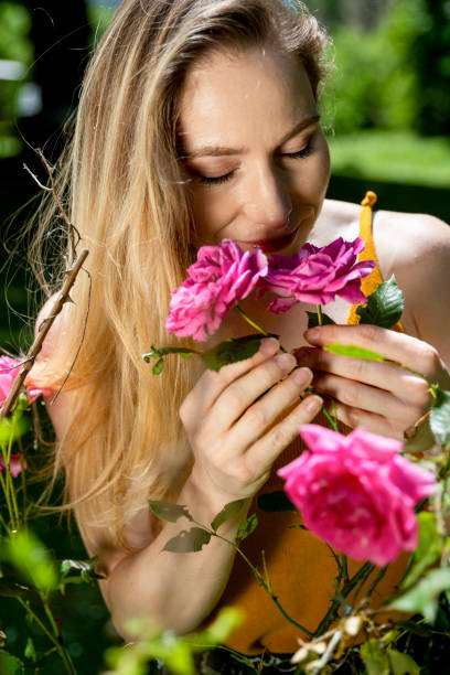 istock Gorgeous woman smelling the roses 1184706197