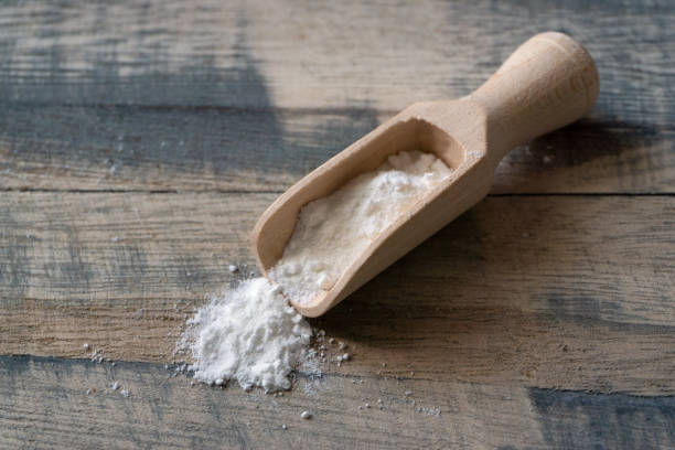 Wheat flour in a wooden scoop stock photo